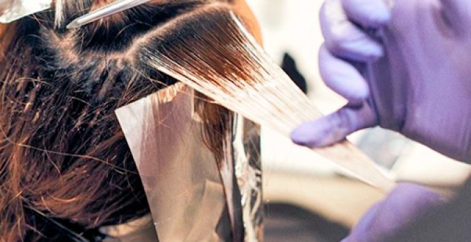 hairdresser applying color with gloves