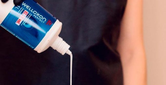 hairdresser mixing developer and dye in a bowl