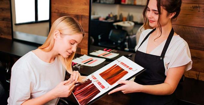 hairdresser helping client to choose hair color
