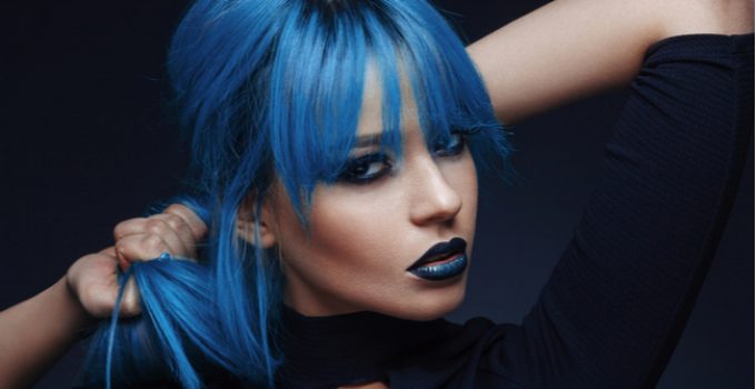woman with blue hair and roots of her natural hair color