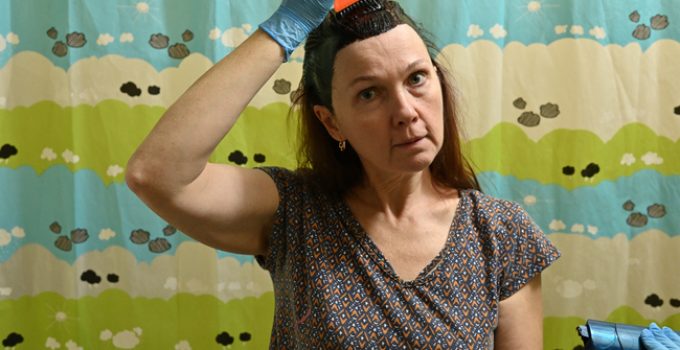 woman dyes her hair brown