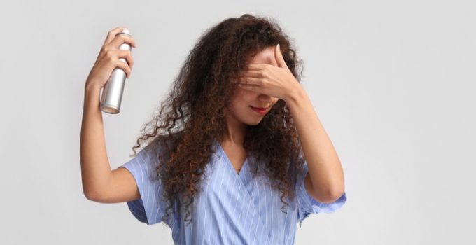 woman applies hair spray every day