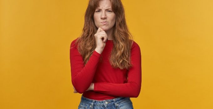 mujer de pelo rojo con dudas