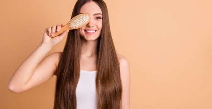 mujer con cepillo en la mano y pelo con rebonding