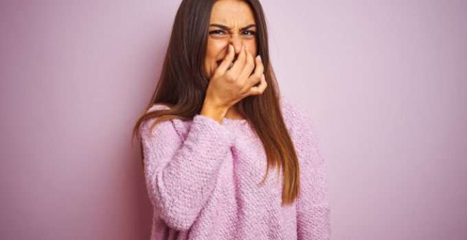 Una chica se tapa la nariz por el mal olor de la keratina