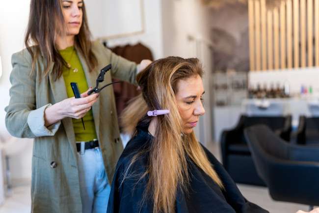 En el salón dividen el pelo de una clienta en cuatro para hacerle mechas